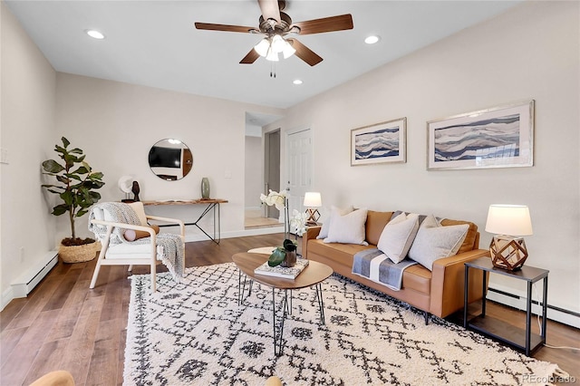 living room with recessed lighting, baseboard heating, ceiling fan, wood finished floors, and baseboards