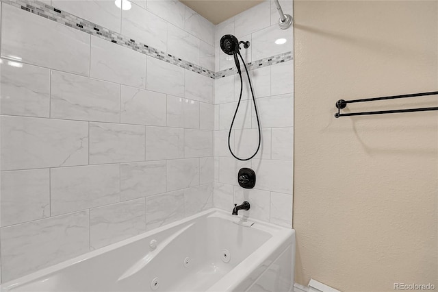 full bath featuring a combined bath / shower with jetted tub and a textured wall