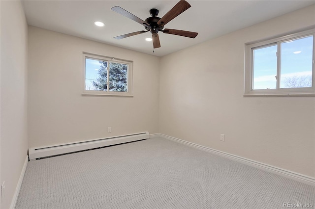 empty room with baseboard heating, carpet flooring, and baseboards