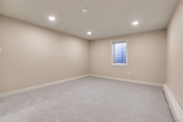 unfurnished room featuring a baseboard heating unit, carpet, baseboards, and recessed lighting