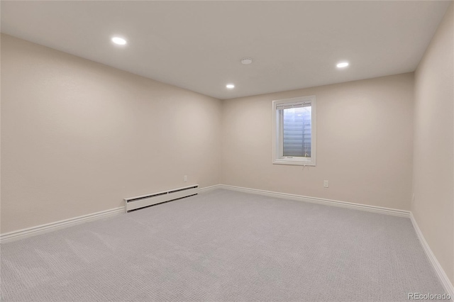 empty room featuring a baseboard heating unit, carpet, baseboards, and recessed lighting