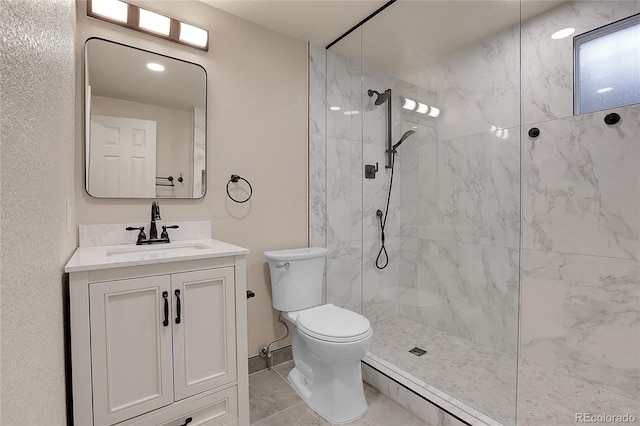 full bath with toilet, a marble finish shower, and vanity