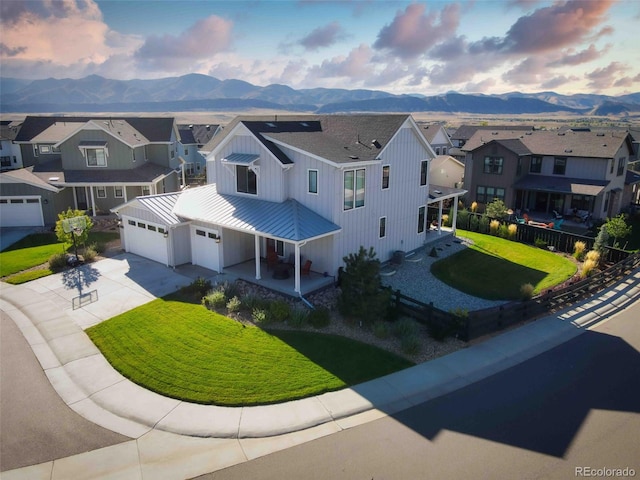 view of front of house featuring a mountain view, a garage, and a front yard