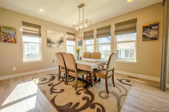 dining room with a notable chandelier and light hardwood / wood-style floors