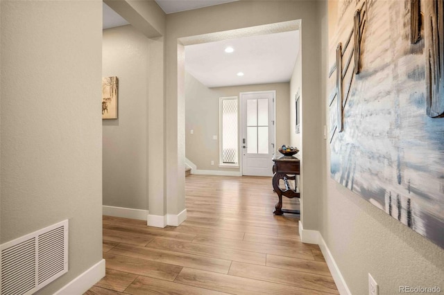 hallway with light hardwood / wood-style flooring