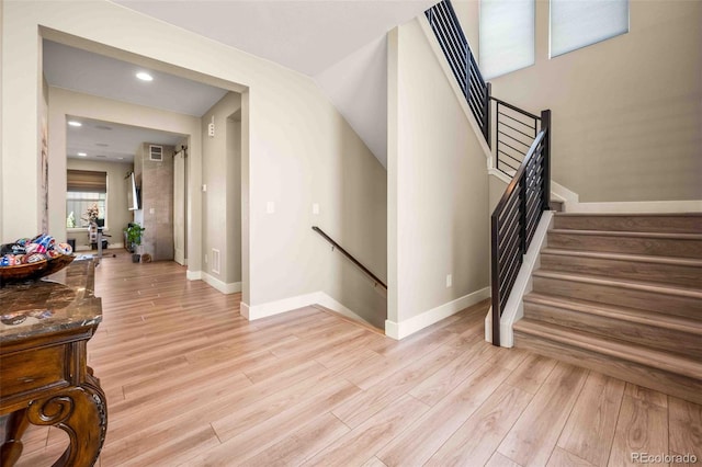 stairway with hardwood / wood-style flooring