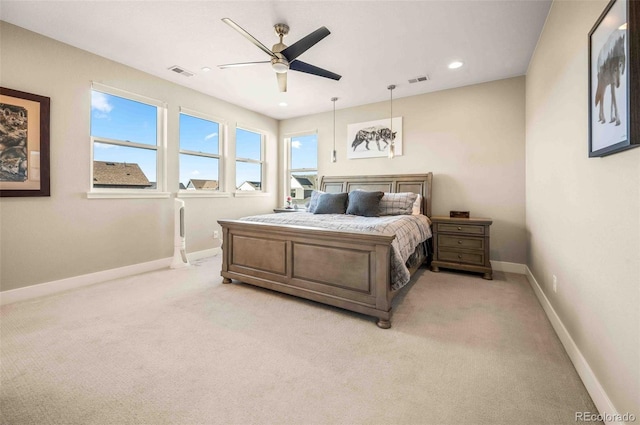 bedroom featuring light colored carpet and ceiling fan