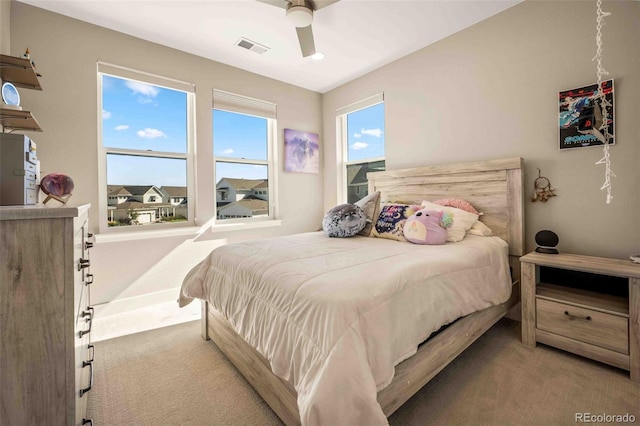 bedroom featuring ceiling fan and light carpet