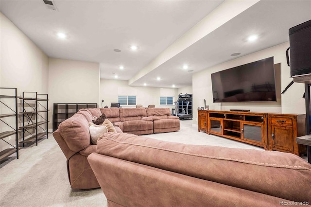 living room with recessed lighting, visible vents, and light colored carpet