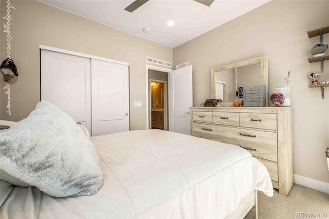 bedroom with baseboards, visible vents, light colored carpet, ceiling fan, and a closet