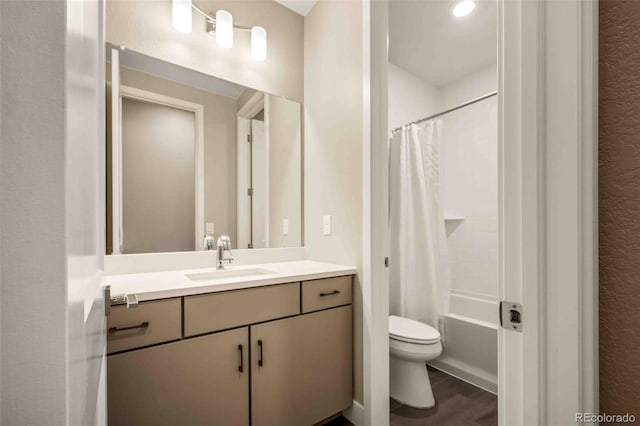 full bathroom with shower / tub combo with curtain, vanity, toilet, and wood finished floors