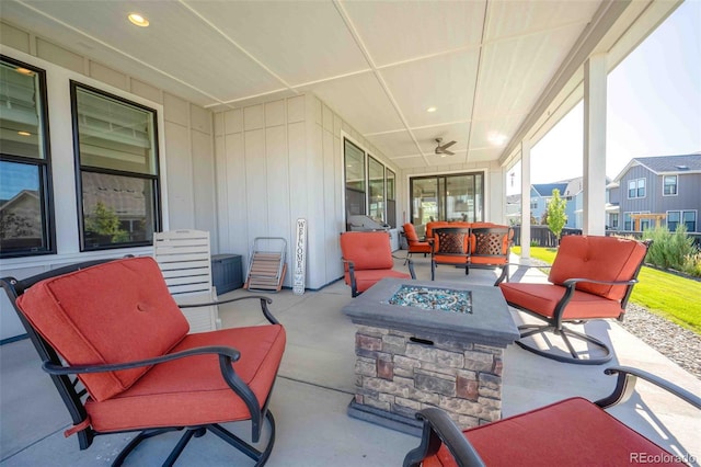 view of patio with ceiling fan and an outdoor living space with a fire pit