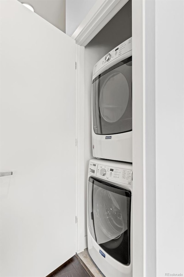 2550 Lawrence St Unit Rb306, Denver, CO 80205 - washroom with stacked washer / dryer and dark wood finished floors