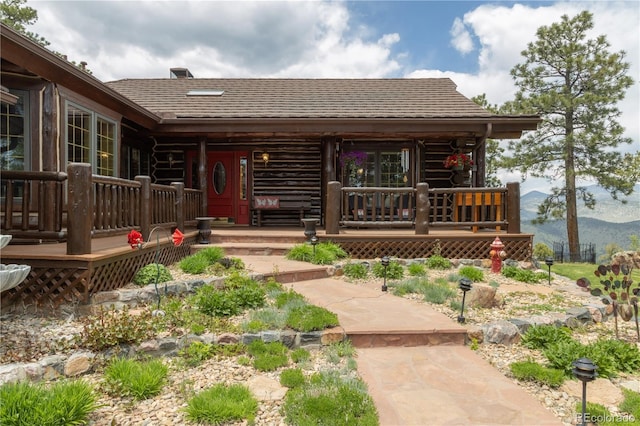 29095 Summit Ranch Dr, Golden, CO 80401 - view of front of home featuring a mountain view, roof with shingles, a porch, and log siding