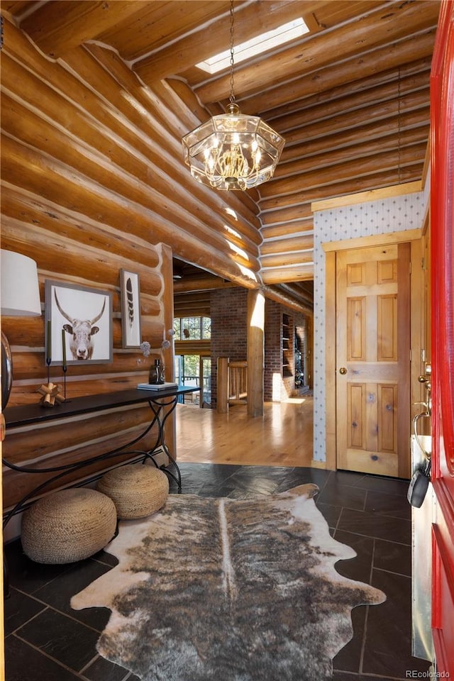 29095 Summit Ranch Dr, Golden, CO 80401 - foyer entrance with log walls, a chandelier, and a towering ceiling