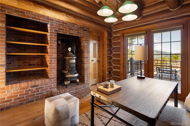 29095 Summit Ranch Dr, Golden, CO 80401 - home office with wood finished floors, log walls, and a chandelier