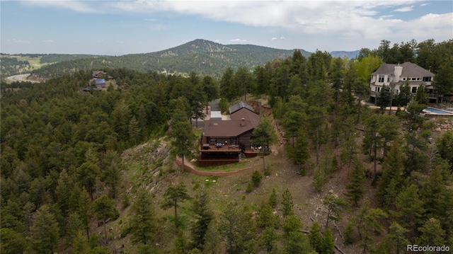 29095 Summit Ranch Dr, Golden, CO 80401 - aerial view of property's location featuring a heavily wooded area and a mountainous background