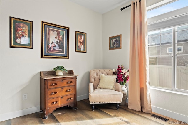 living area with hardwood / wood-style flooring