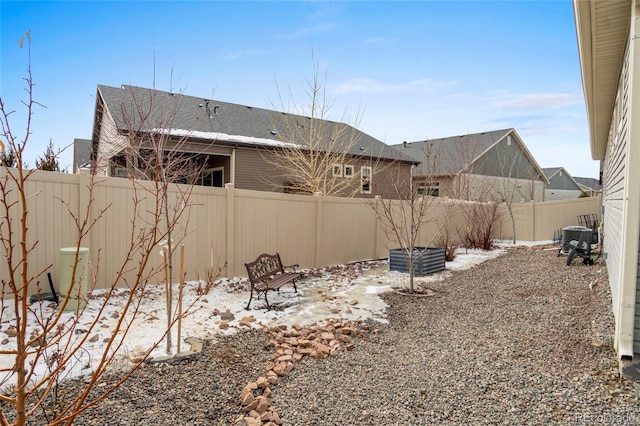 yard covered in snow featuring central AC unit