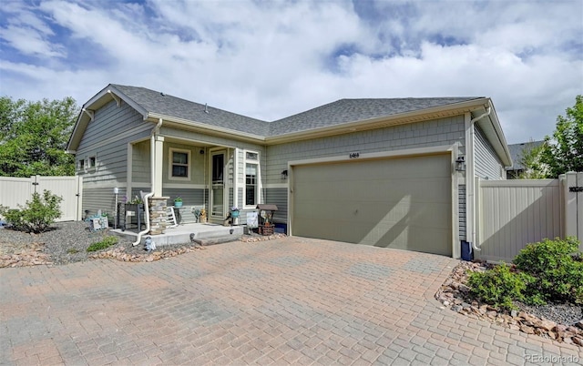 6484 Golden Briar Ln, Colorado Springs, CO 80927 - ranch-style home featuring a garage, covered porch, driveway, roof with shingles, and a gate