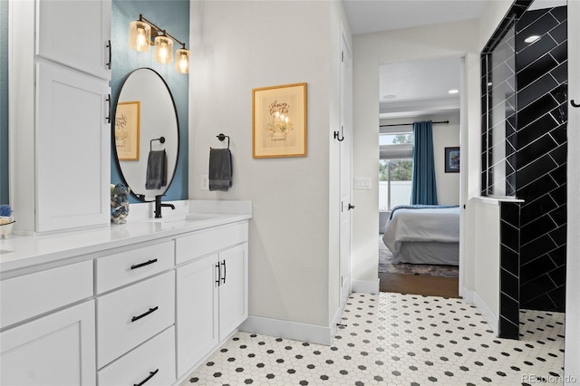 6484 Golden Briar Ln, Colorado Springs, CO 80927 - bathroom with ensuite bath, double vanity, baseboards, and tiled shower