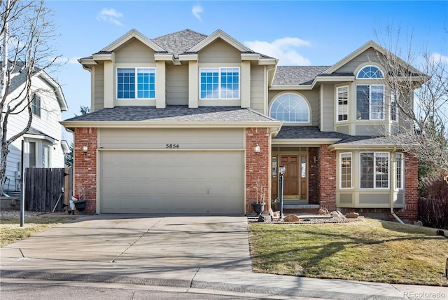 view of property featuring a garage and a front yard