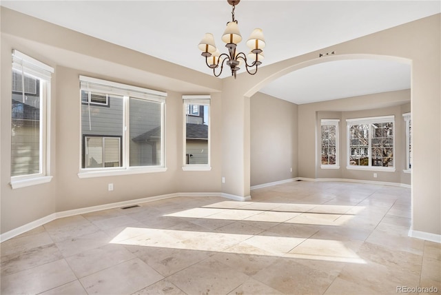 empty room featuring a notable chandelier