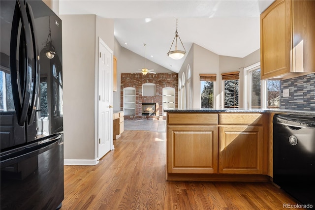 kitchen featuring decorative backsplash, light wood-type flooring, ceiling fan, black appliances, and pendant lighting