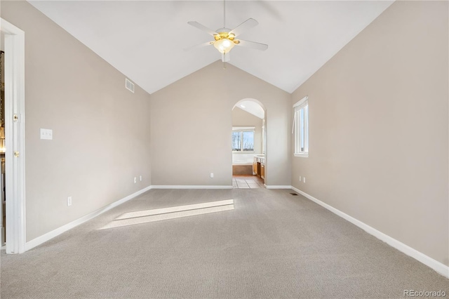 carpeted empty room featuring ceiling fan and lofted ceiling