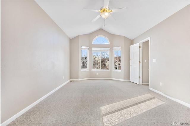 empty room with carpet floors, vaulted ceiling, and ceiling fan