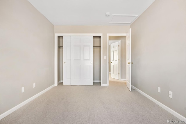 unfurnished bedroom with light carpet and a closet