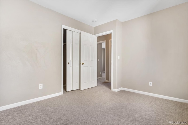 unfurnished bedroom featuring carpet and a closet