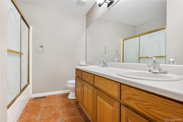 full bathroom with tile patterned flooring, vanity, toilet, and bath / shower combo with glass door