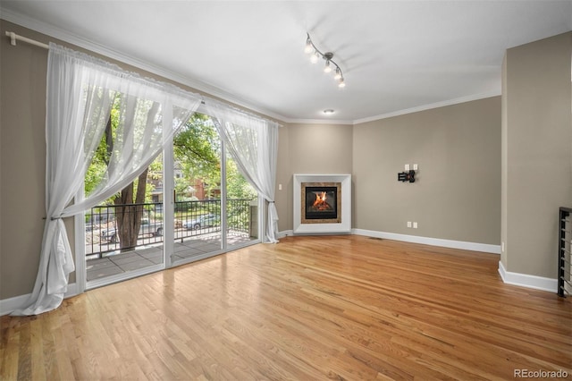 1635 N Franklin St, Denver, CO 80218 - unfurnished living room featuring a glass covered fireplace, baseboards, crown molding, wood finished floors, and track lighting