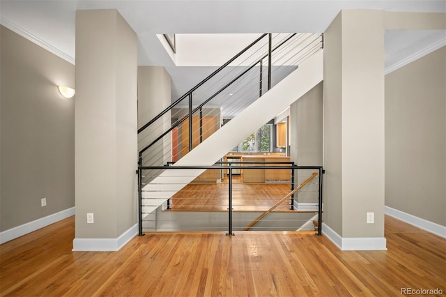 1635 N Franklin St, Denver, CO 80218 - staircase featuring baseboards, ornamental molding, wood finished floors, and a skylight