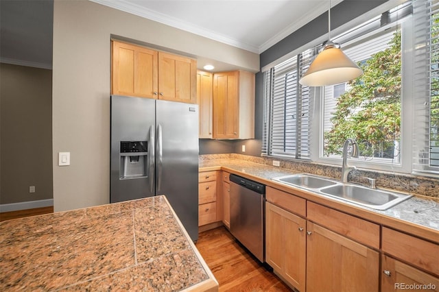 1635 N Franklin St, Denver, CO 80218 - kitchen with stainless steel appliances, a sink, light wood finished floors, ornamental molding, and tile counters
