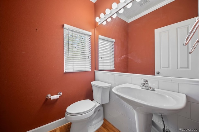 1635 N Franklin St, Denver, CO 80218 - half bathroom featuring toilet, wood finished floors, and ornamental molding
