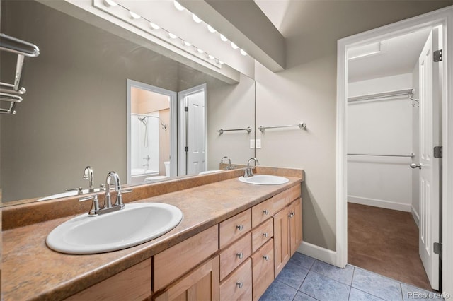1635 N Franklin St, Denver, CO 80218 - bathroom featuring double vanity, tile patterned floors, baseboards, and tub / shower combination