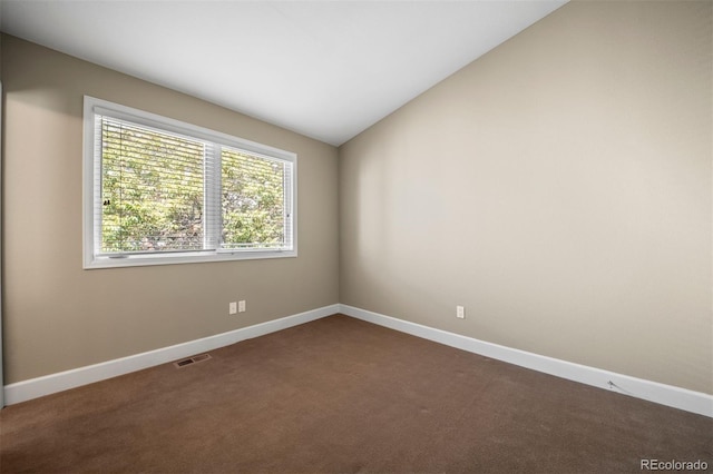 1635 N Franklin St, Denver, CO 80218 - spare room featuring dark colored carpet, baseboards, and vaulted ceiling