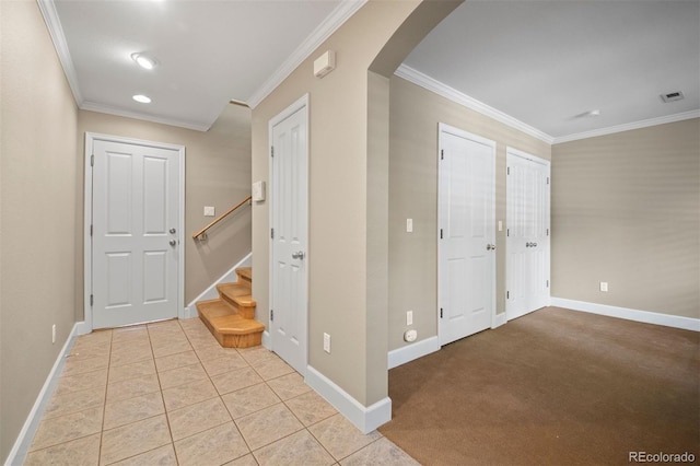 1635 N Franklin St, Denver, CO 80218 - foyer entrance with arched walkways, crown molding, baseboards, stairway, and light tile patterned floors