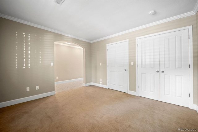 1635 N Franklin St, Denver, CO 80218 - unfurnished bedroom featuring carpet flooring, arched walkways, ornamental molding, and baseboards