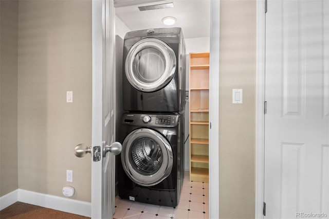 1635 N Franklin St, Denver, CO 80218 - washroom with stacked washer / dryer and baseboards