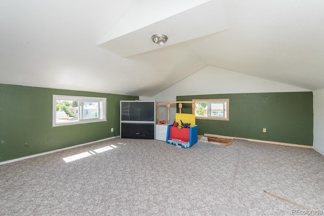 game room featuring lofted ceiling, a healthy amount of sunlight, baseboards, and carpet floors