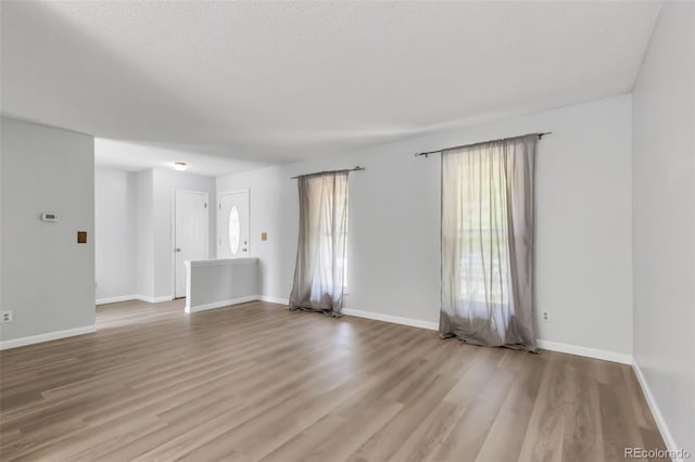 1005 S Lewiston Way, Aurora, CO 80017 - unfurnished room with wood finished floors and baseboards