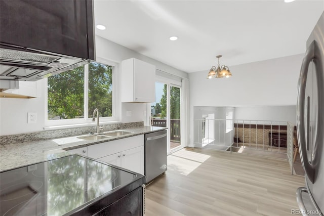 1005 S Lewiston Way, Aurora, CO 80017 - kitchen with stainless steel appliances, a sink, light stone countertops, a chandelier, and white cabinetry