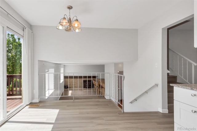 1005 S Lewiston Way, Aurora, CO 80017 - detailed view of a chandelier, wood finished floors, and baseboards