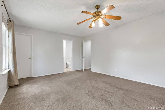 1005 S Lewiston Way, Aurora, CO 80017 - carpeted empty room featuring a ceiling fan, baseboards, and a barn door