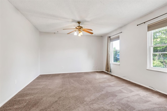 1005 S Lewiston Way, Aurora, CO 80017 - carpeted empty room with plenty of natural light, ceiling fan, a textured ceiling, and baseboards