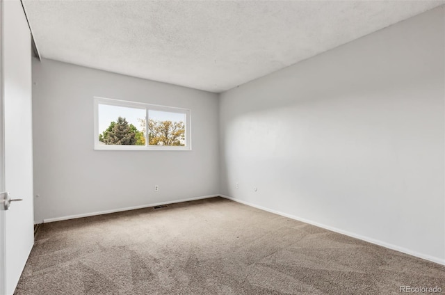 1005 S Lewiston Way, Aurora, CO 80017 - carpeted spare room with baseboards and a textured ceiling
