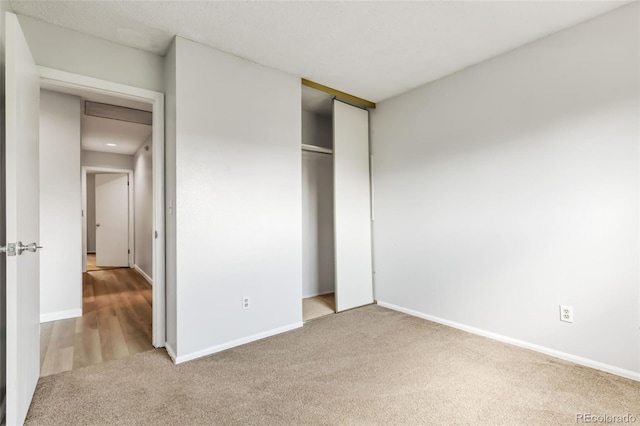 1005 S Lewiston Way, Aurora, CO 80017 - unfurnished bedroom with carpet flooring, baseboards, and a closet